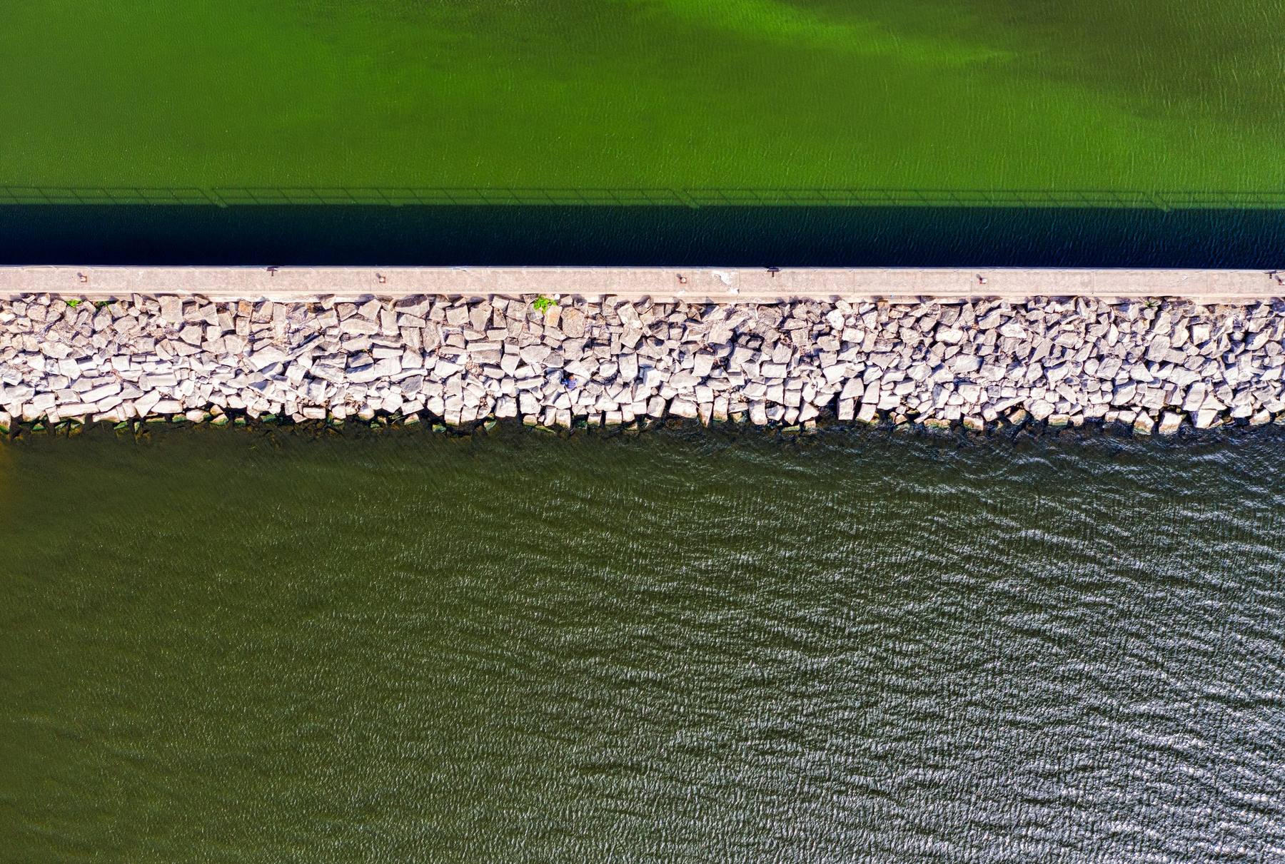 Aerial view of a pier and stone breakwater on a lake