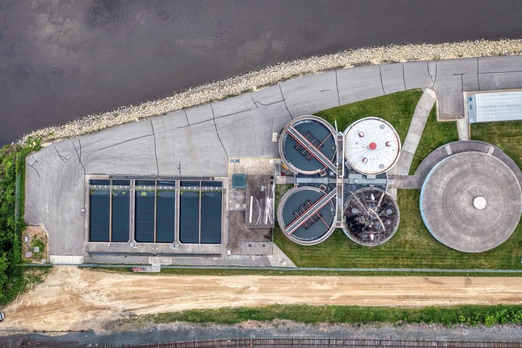 Aerial view of a water treatment plant beside a river